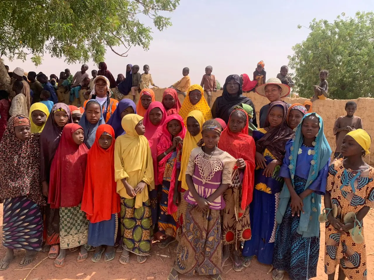 Women and children gathered at a Go Green Nigeria Foundation community visit